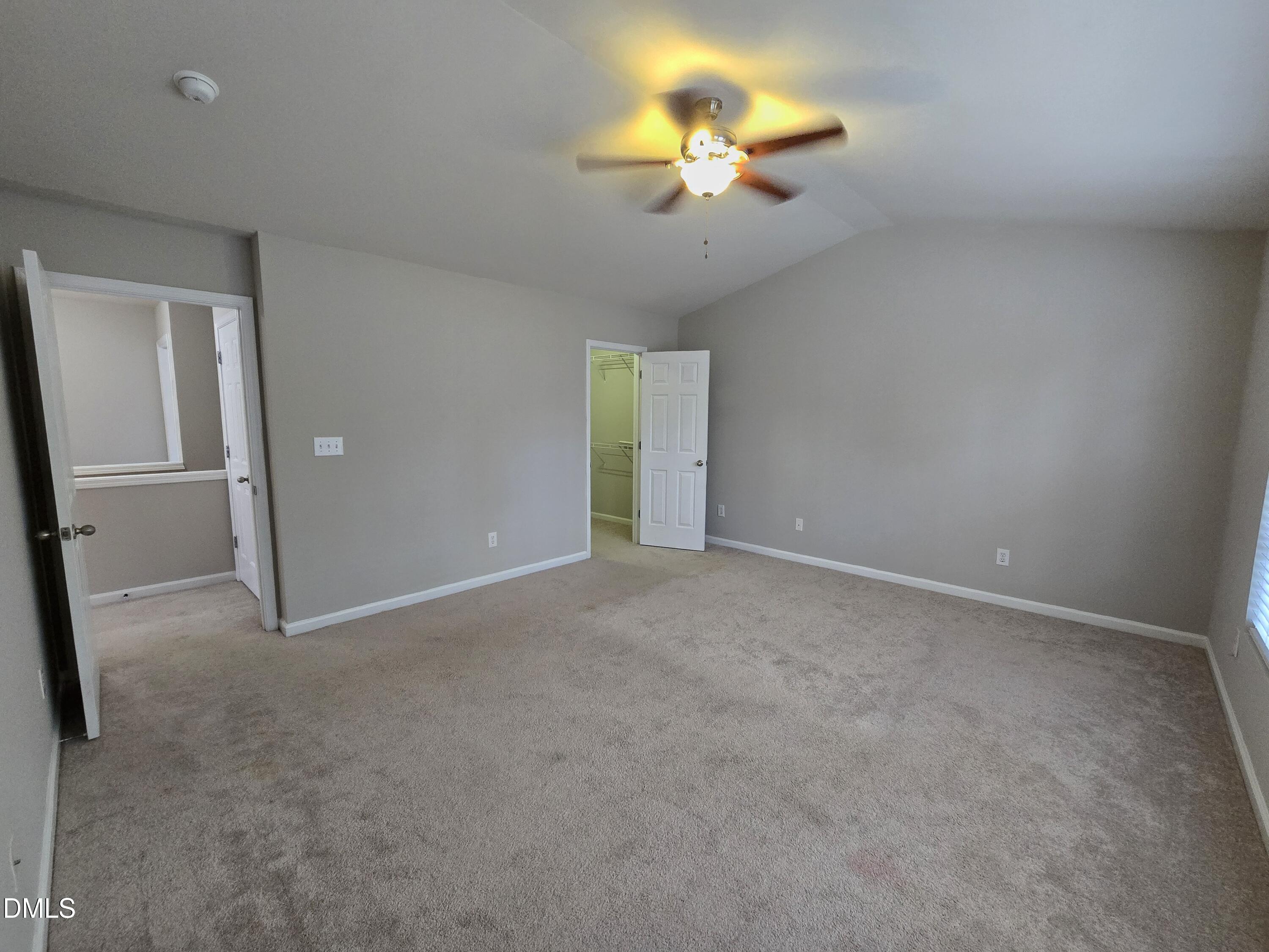 5030 Reservoir Road Raleigh, NC 27610 - Photo 26 of 31 an empty room with a chandelier fan and windows