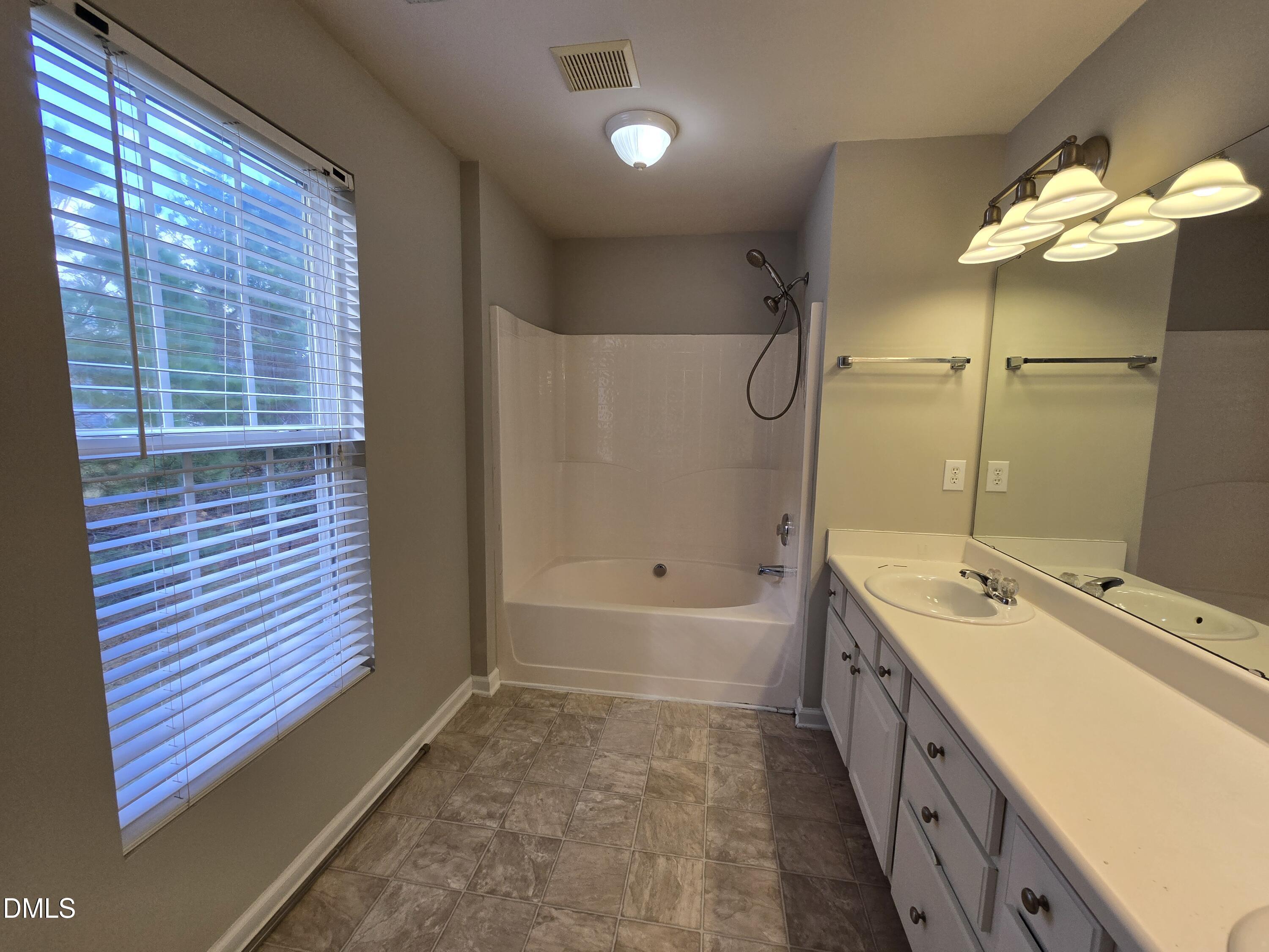 5030 Reservoir Road Raleigh, NC 27610 - Photo 29 of 31 a bathroom with a tub sink and mirror