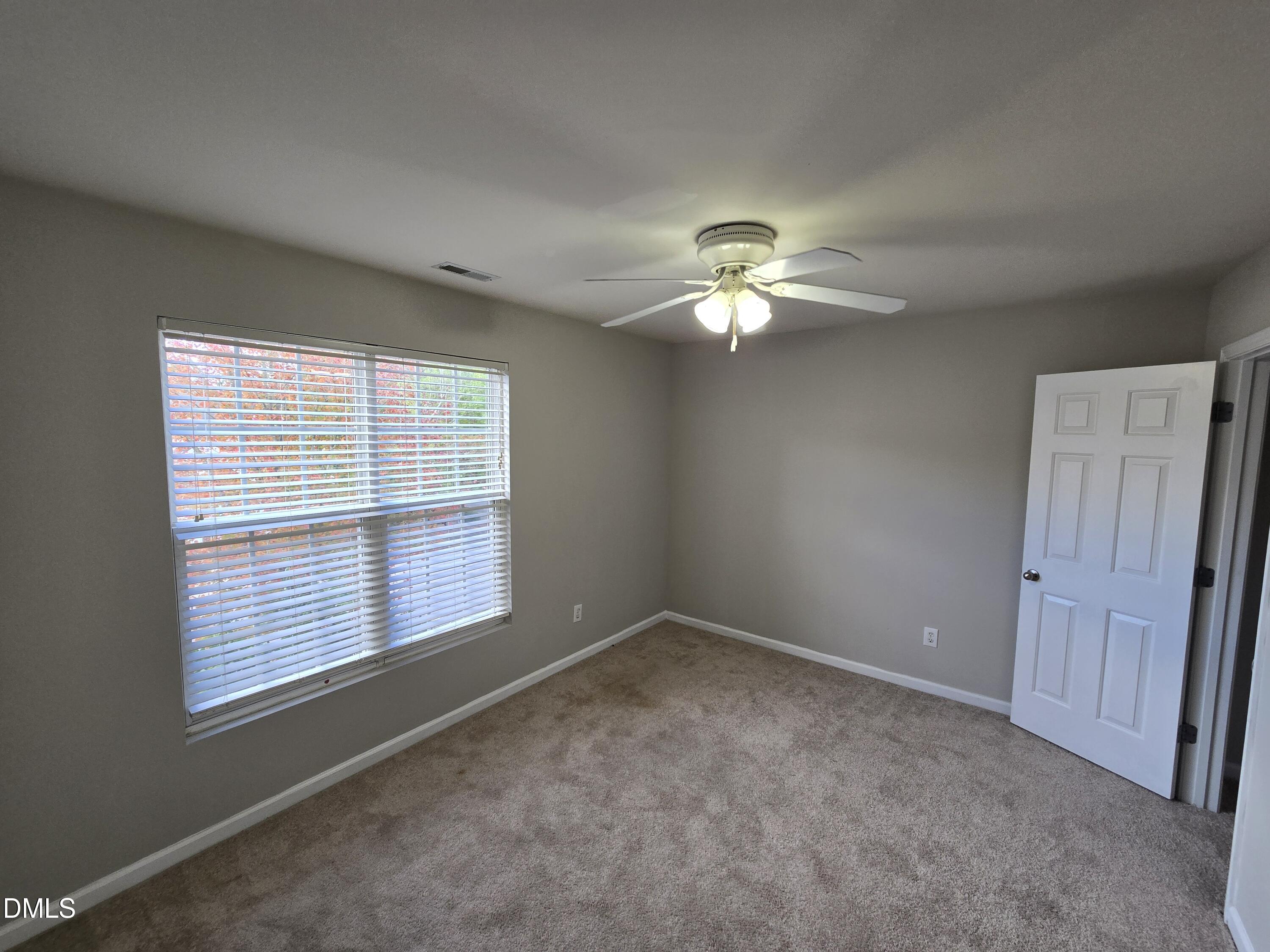 5030 Reservoir Road Raleigh, NC 27610 - Photo 30 of 31 a view of a livingroom with a chandelier fan and a large window