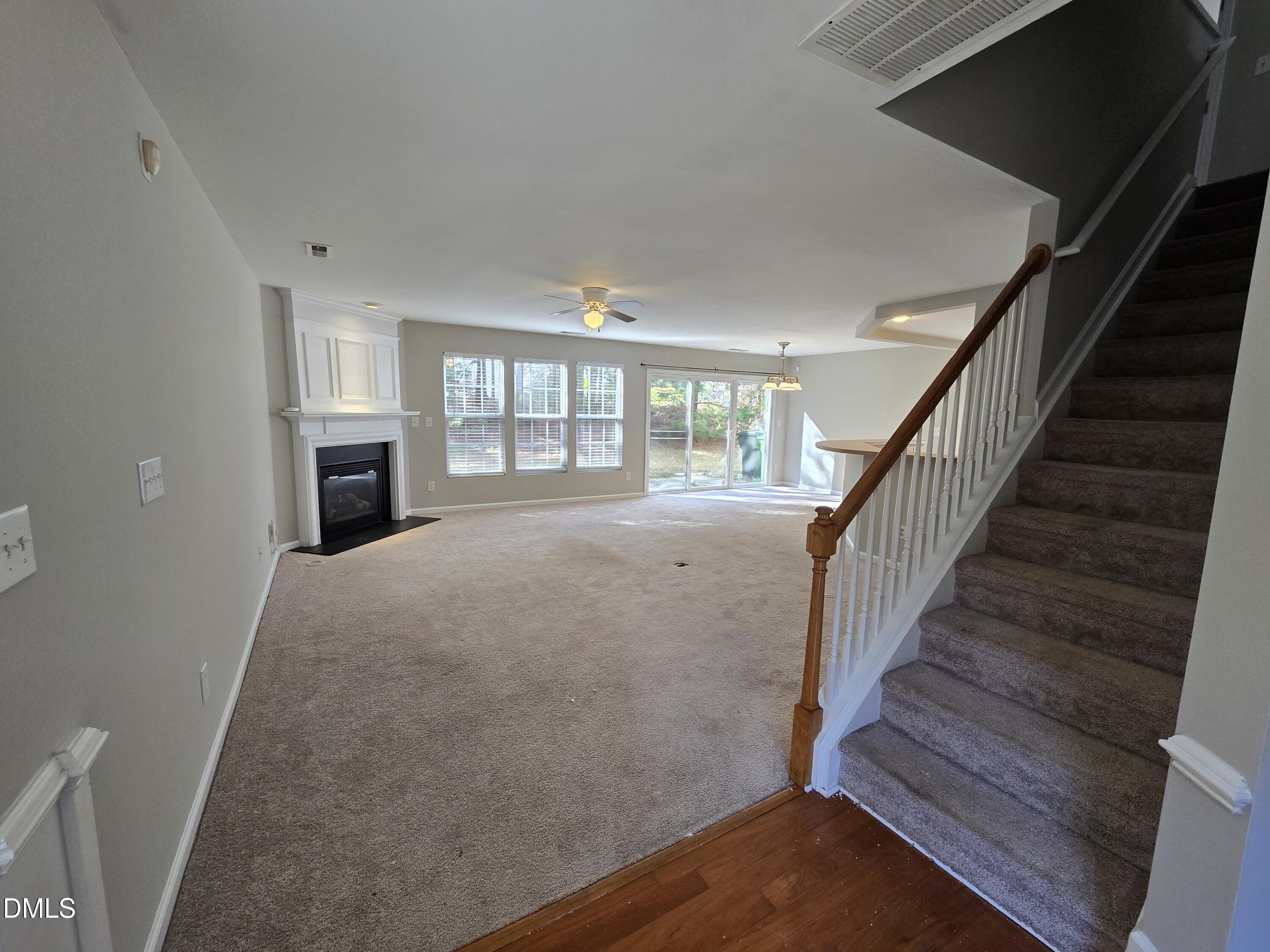 5030 Reservoir Road Raleigh, NC 27610 - Photo 6 of 31 a view of an empty room with wooden floor and a window