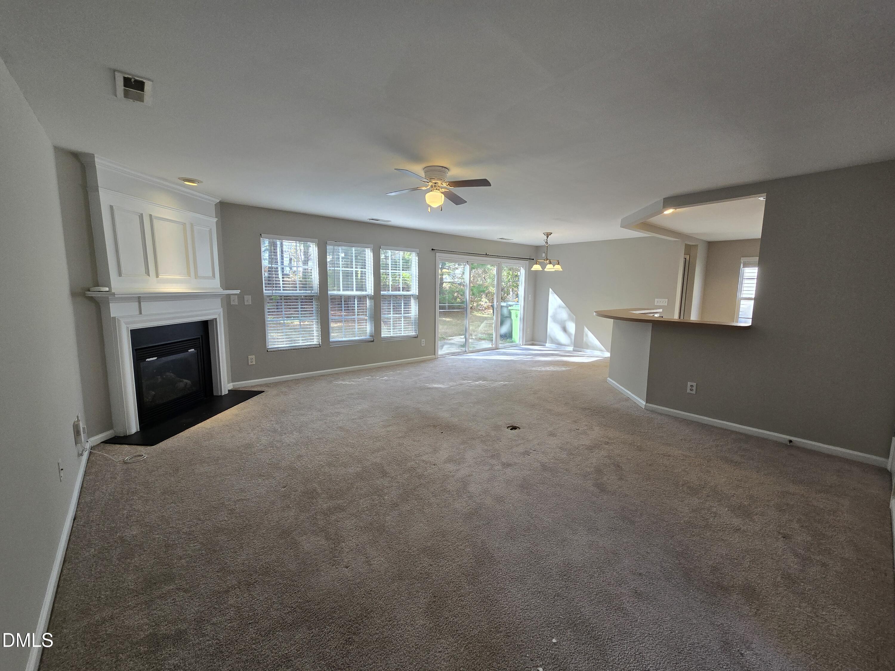 5030 Reservoir Road Raleigh, NC 27610 - Photo 8 of 31 an empty room with windows and fireplace