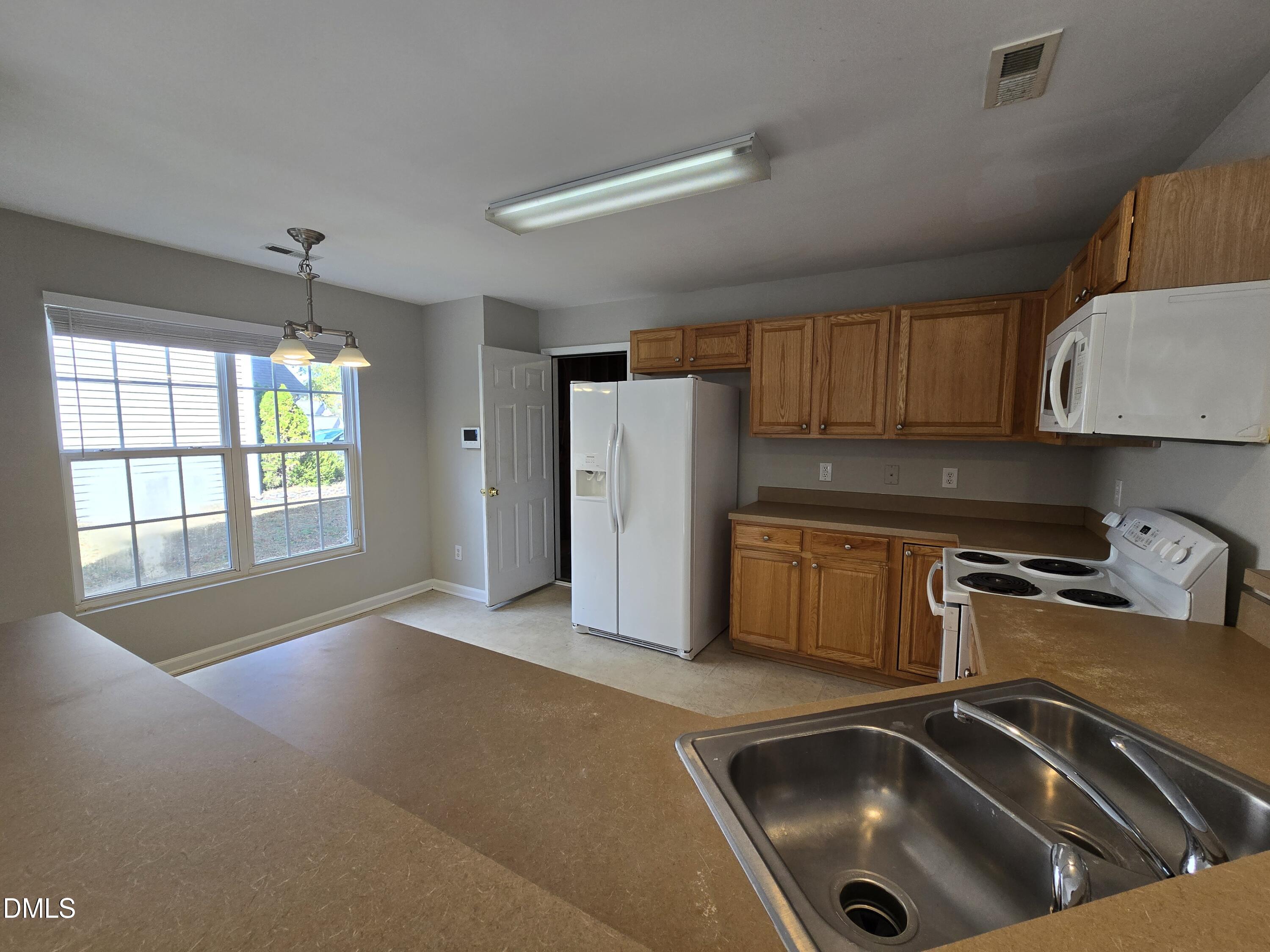 5030 Reservoir Road Raleigh, NC 27610 - Photo 9 of 31 a kitchen that has a sink and a stove in it