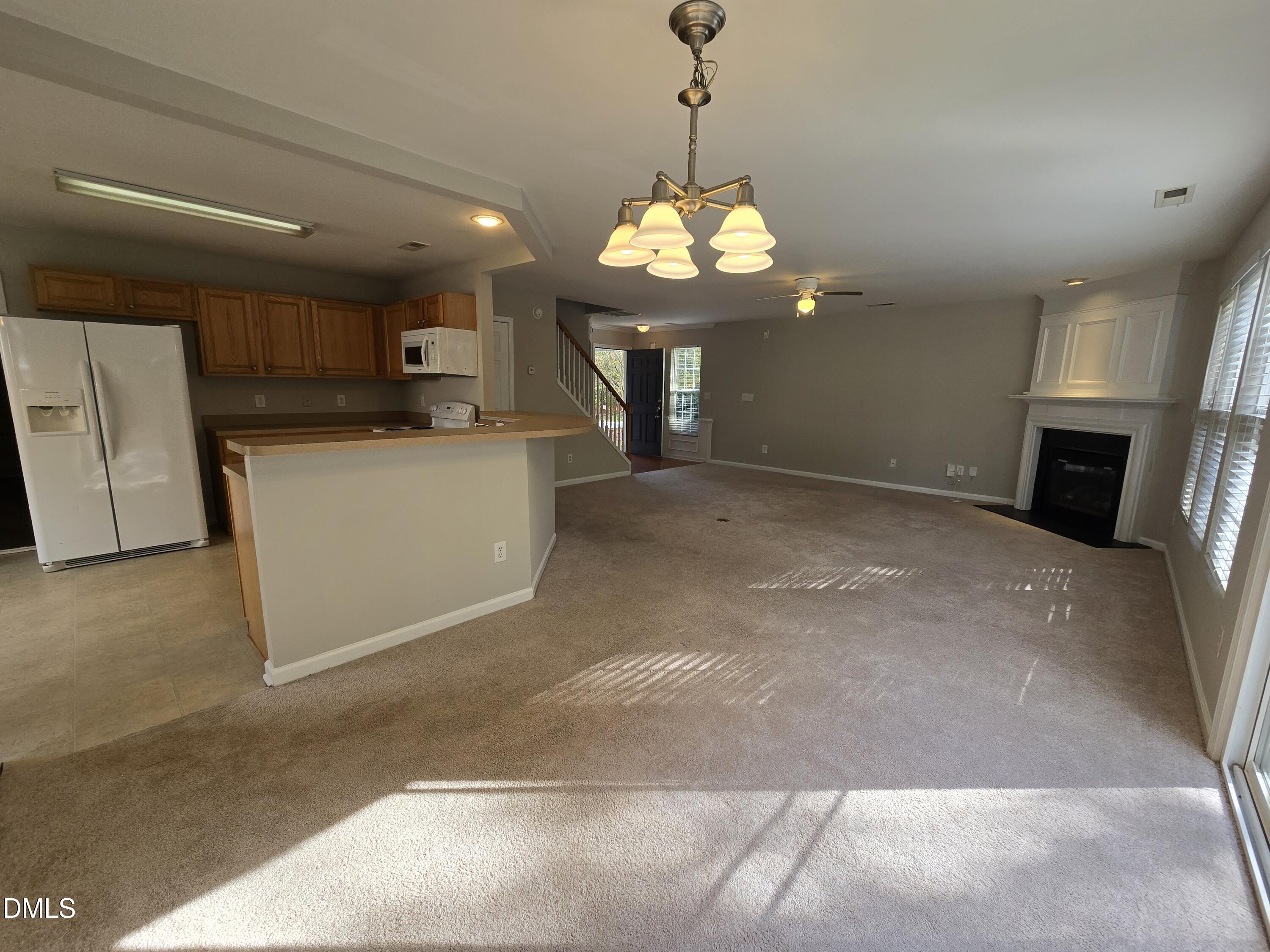 5030 Reservoir Road Raleigh, NC 27610 - Photo 10 of 31 a view of a kitchen with a sink and a chandelier