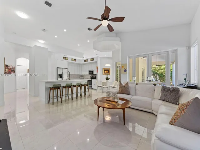 a bathroom with a granite countertop sink a large mirror and a bathtub