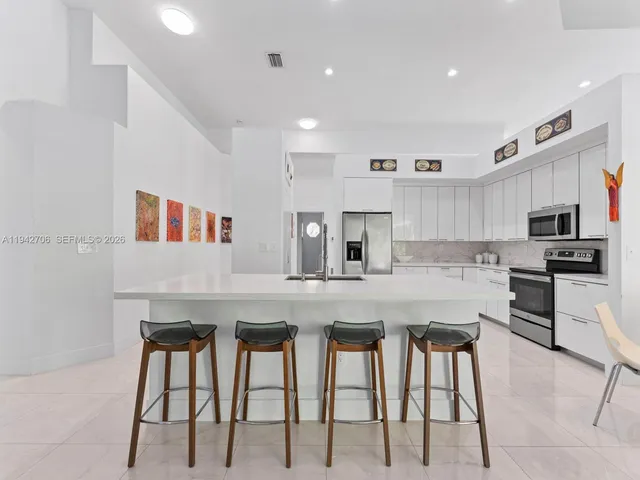 a white toilet sitting next to a bathroom sink and vanity