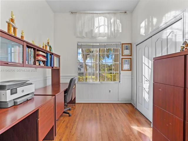 a front view of a house with a yard and fountain