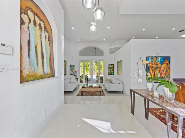 a view of a dining room with furniture wooden floor and a chandelier