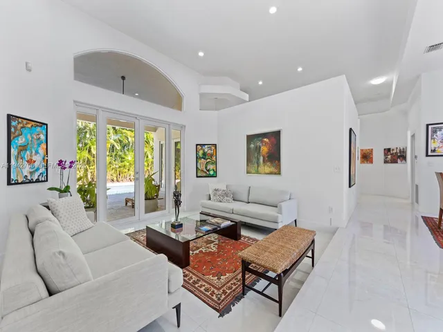 a kitchen with stainless steel appliances kitchen island granite countertop a table and chairs in it