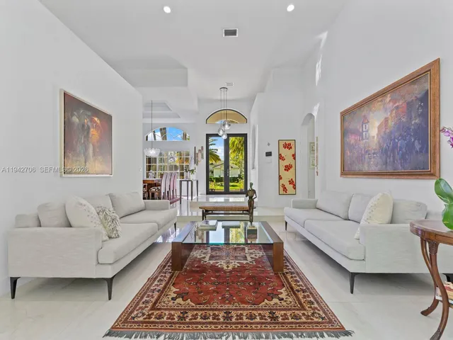 a kitchen with stainless steel appliances granite countertop a table chairs sink and cabinets