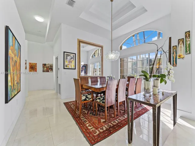 a kitchen with appliances and chairs in it