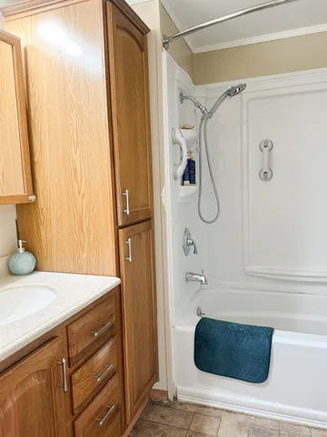 a bathroom with a tub and a shower