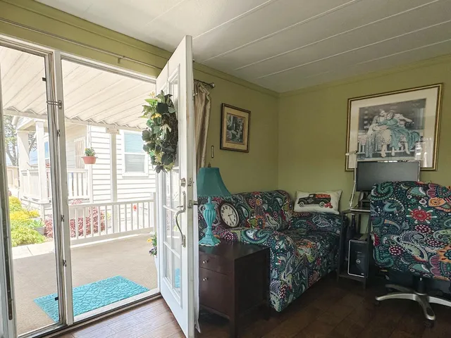 a living room with furniture and a floor to ceiling window