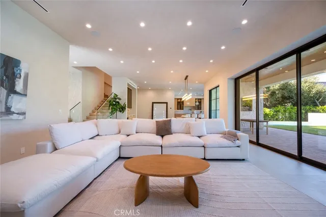 a large kitchen with kitchen island a sink a stove a dining table and chairs