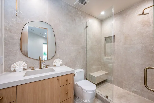 a bedroom with a bed and a potted plant