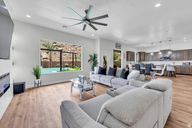 6105 Bunda Way St. George, UT 84790 - Photo 5 of 49 Spacious open-concept living area featuring wood-finish flooring, recessed lighting, and a modern ceiling fan
