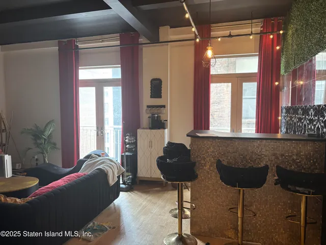 a living room with furniture and large windows