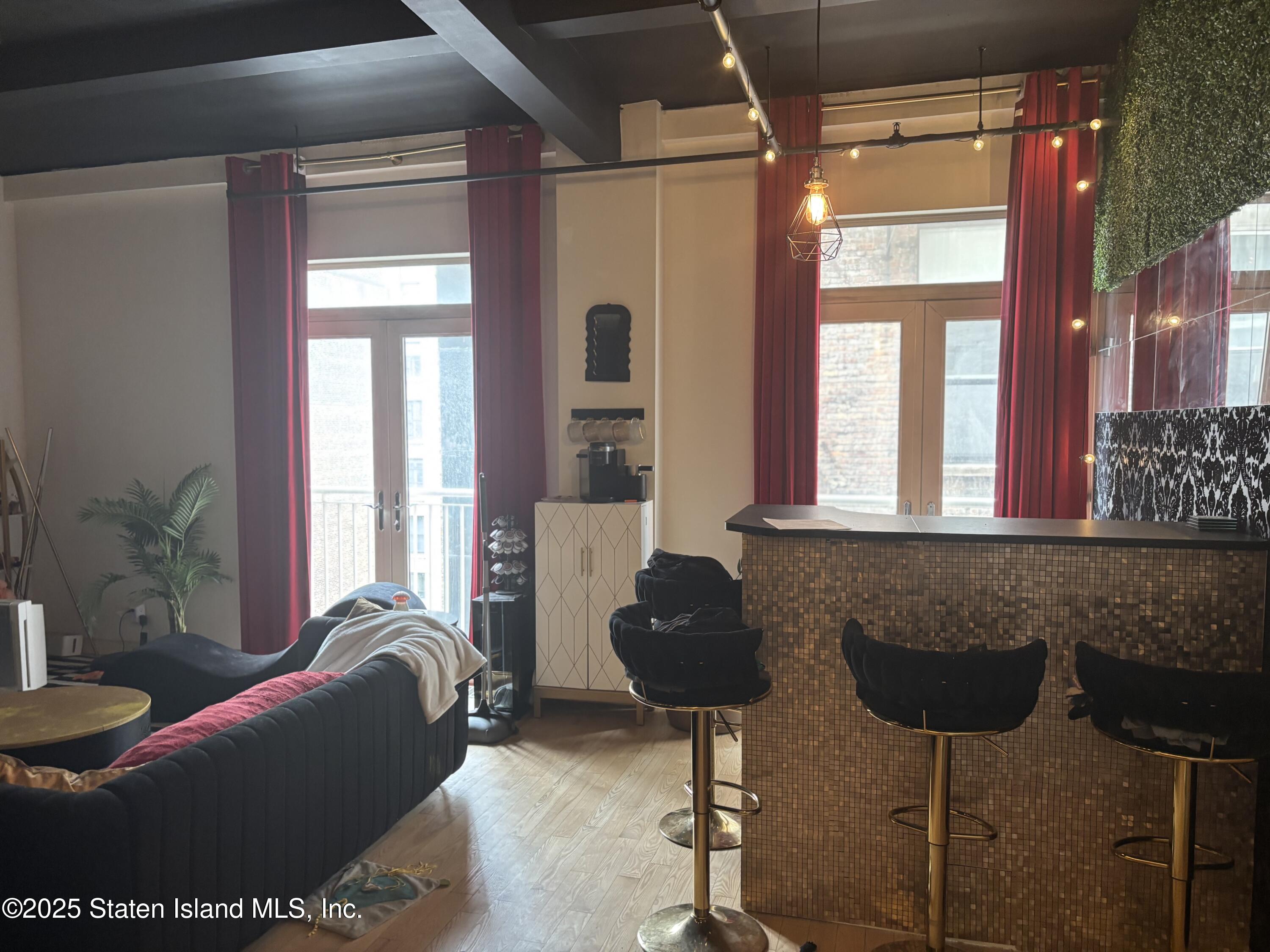 16 West 19th Street, Unit 9F Manhattan, NY 10011 - Photo 1 of 32 a living room with furniture and large windows