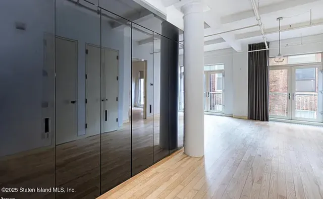 a view of hallway with wooden floor