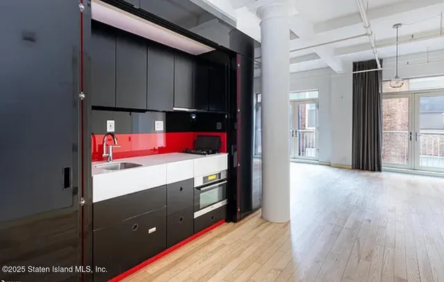 a kitchen with a refrigerator and window
