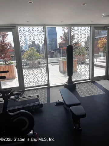 a room with pool table and windows