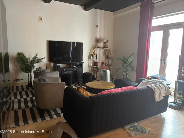 a bedroom with furniture and a flat screen tv