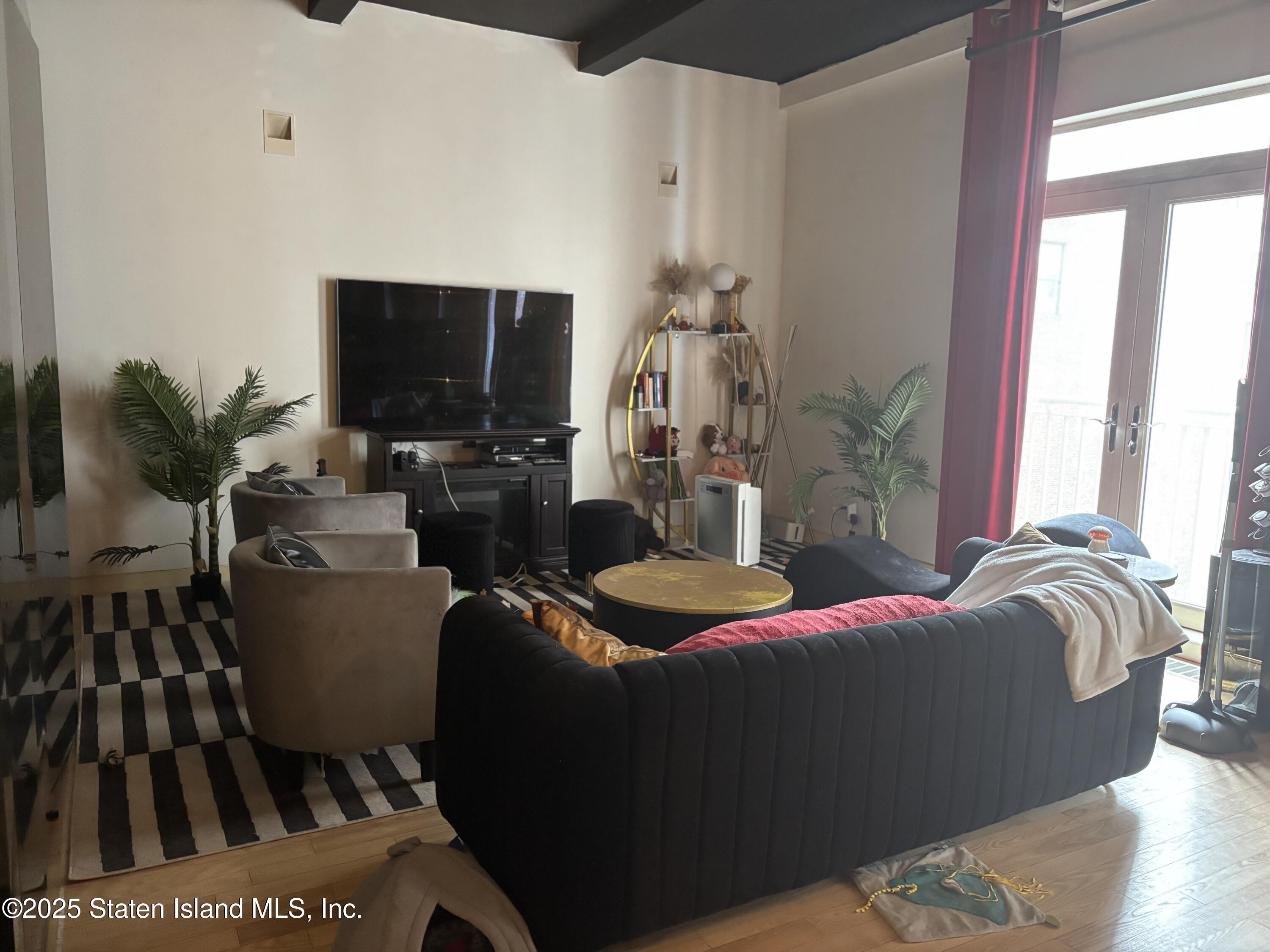 16 West 19th Street, Unit 9F Manhattan, NY 10011 - Photo 3 of 32 a bedroom with furniture and a flat screen tv