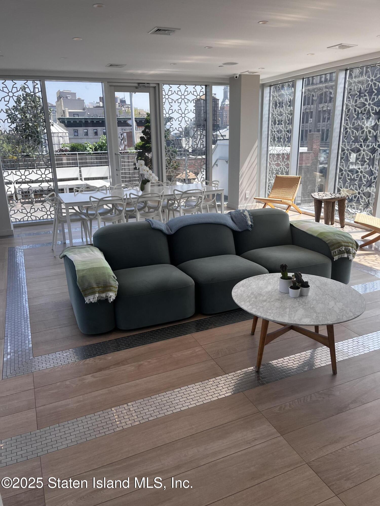 16 West 19th Street, Unit 9F Manhattan, NY 10011 - Photo 32 of 32 a living room with furniture and a large window