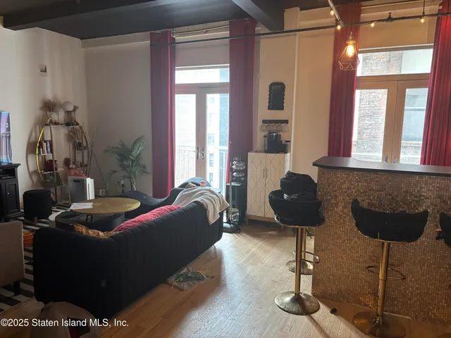 a living room with furniture and a floor to ceiling window