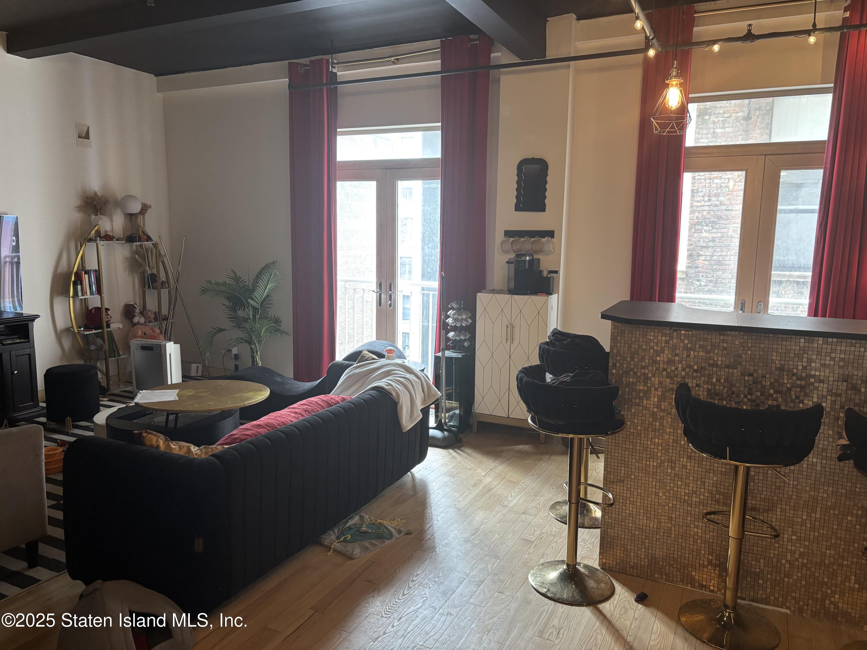 16 West 19th Street, Unit 9F Manhattan, NY 10011 - Photo 4 of 32 a living room with furniture and a floor to ceiling window