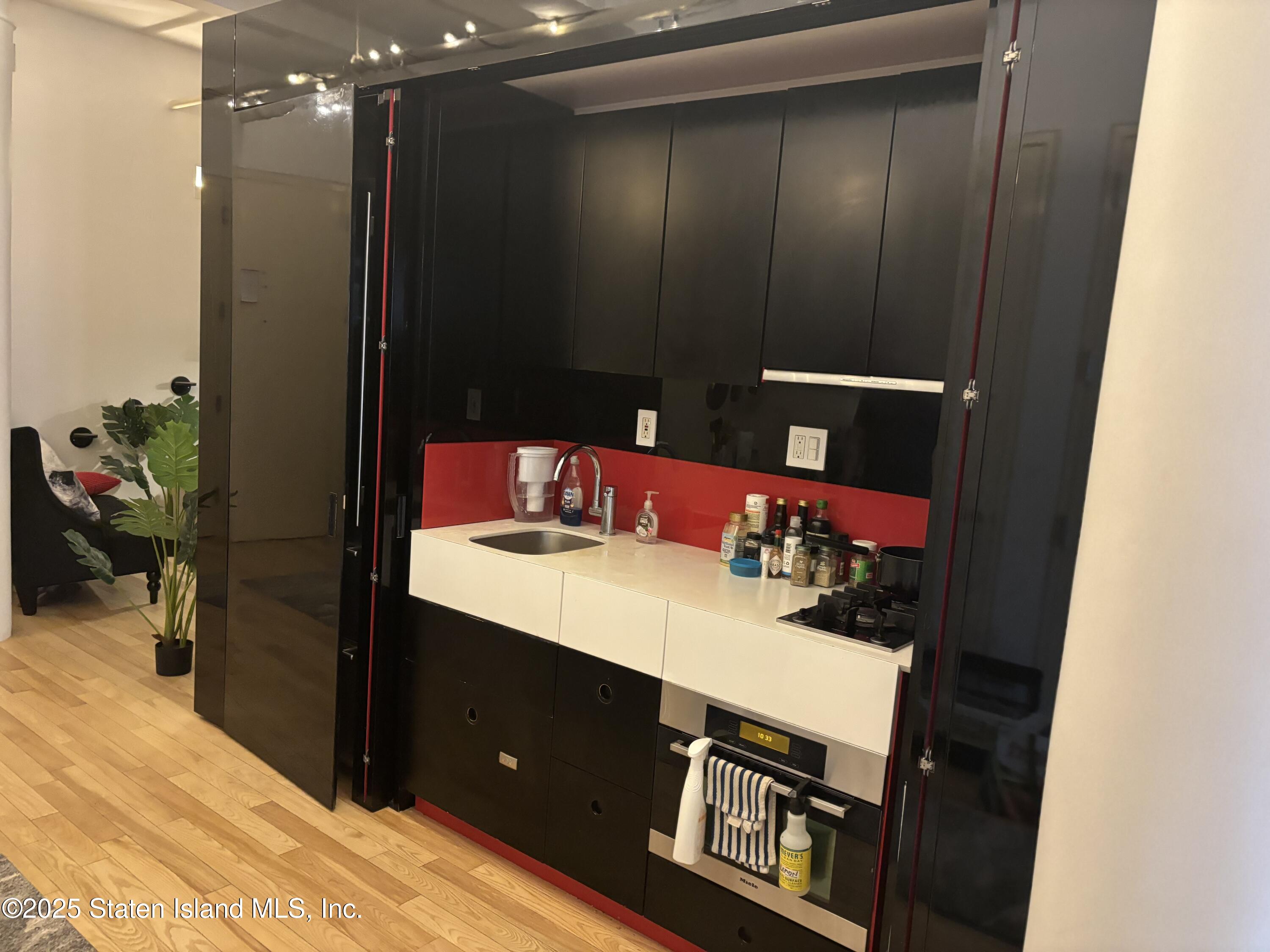 16 West 19th Street, Unit 9F Manhattan, NY 10011 - Photo 7 of 32 a bathroom with a sink vanity and a mirror