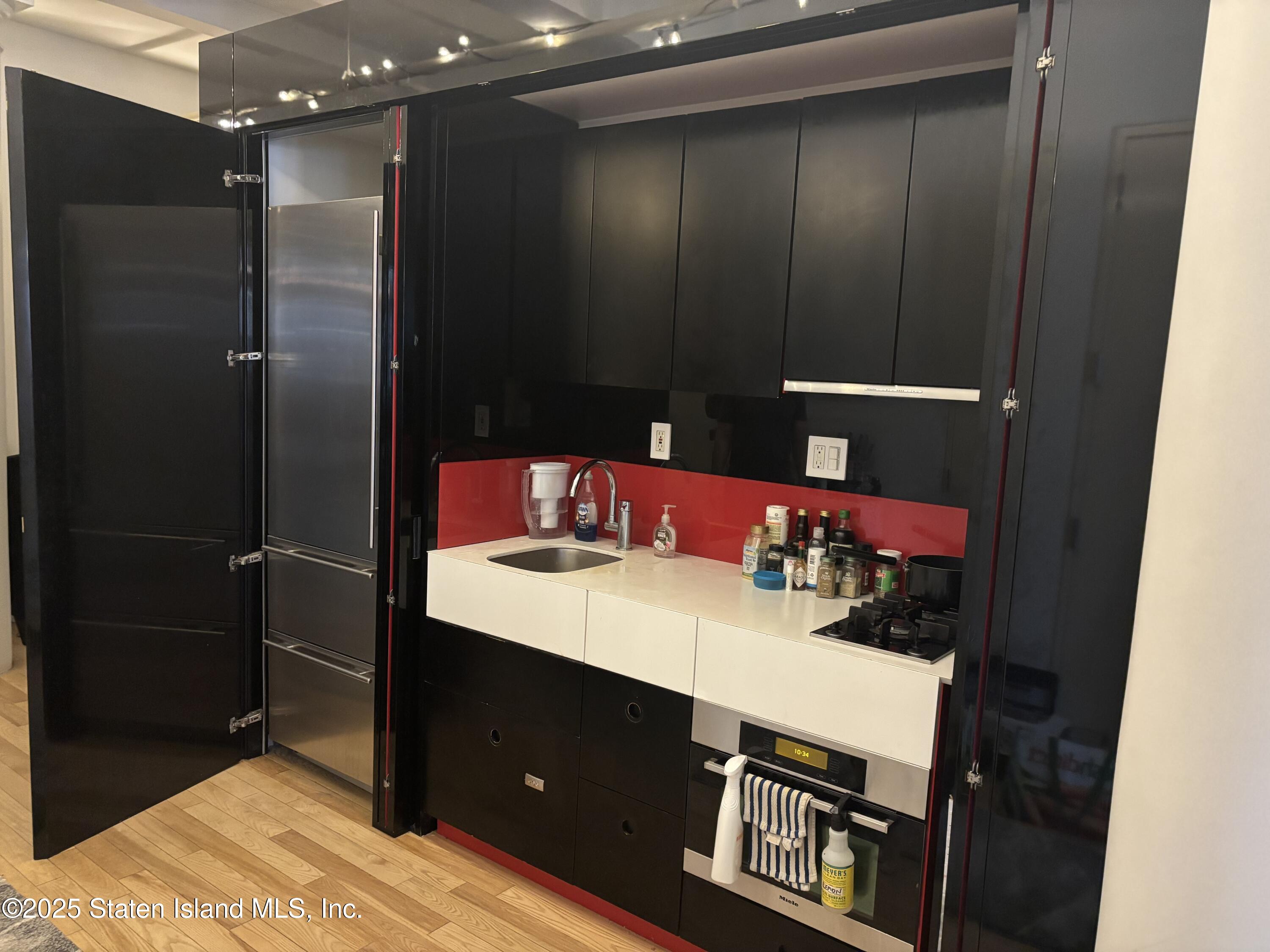 16 West 19th Street, Unit 9F Manhattan, NY 10011 - Photo 8 of 32 a bathroom with a sink vanity and a mirror