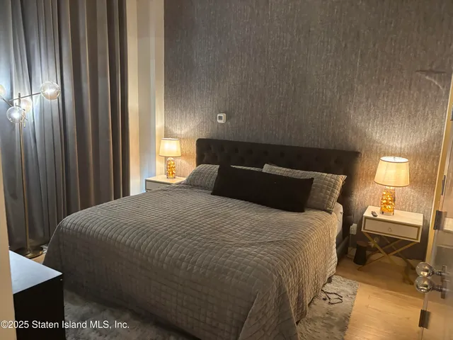 a bedroom with a bed and a mirror