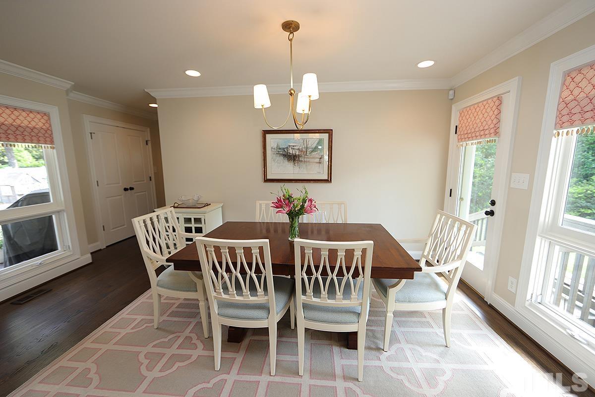 410 Marlowe Road Raleigh, NC 27609 - Photo 11 of 23 a dining room with furniture a chandelier and wooden floor