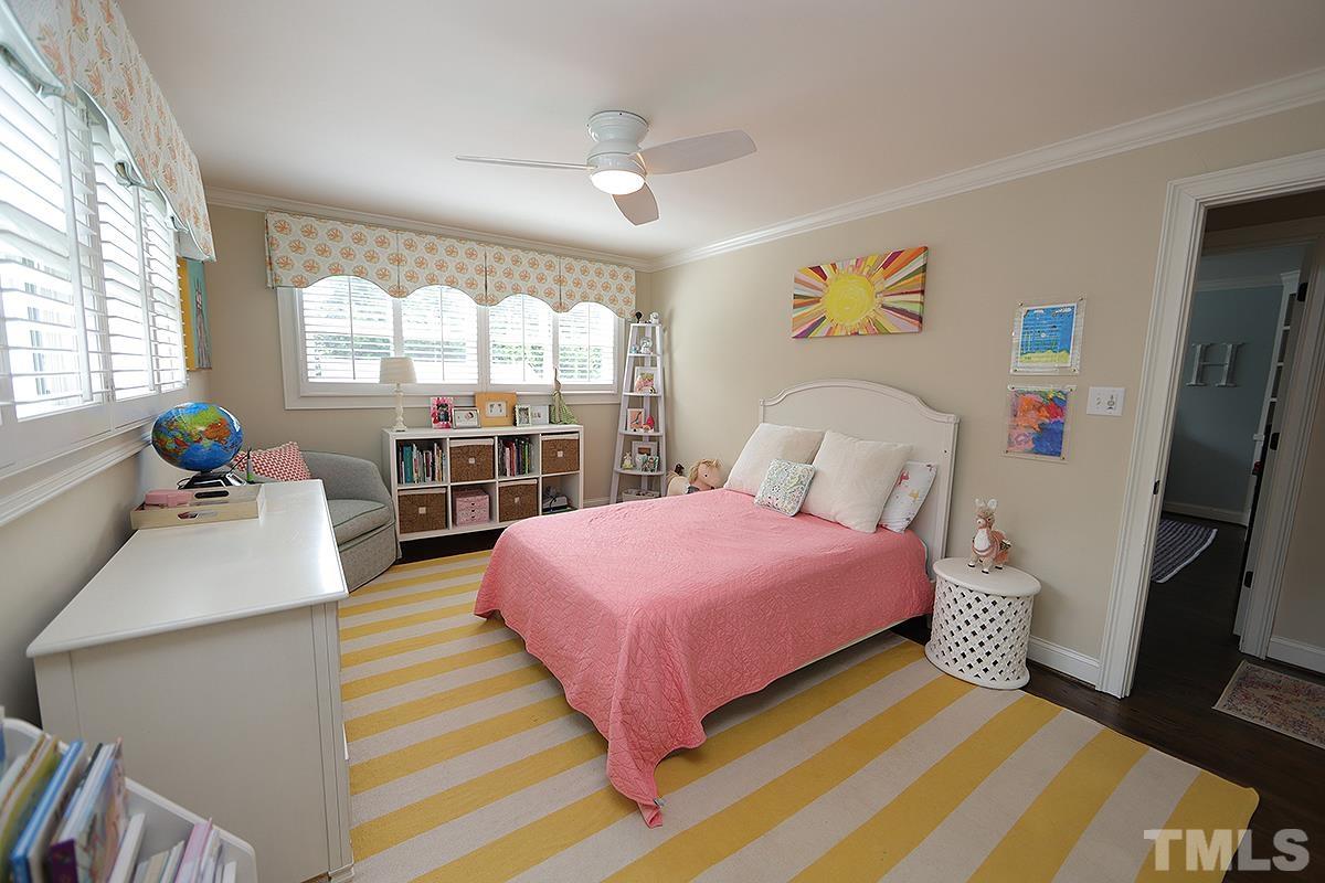 410 Marlowe Road Raleigh, NC 27609 - Photo 15 of 23 a bedroom with a bed a large window with table and chairs