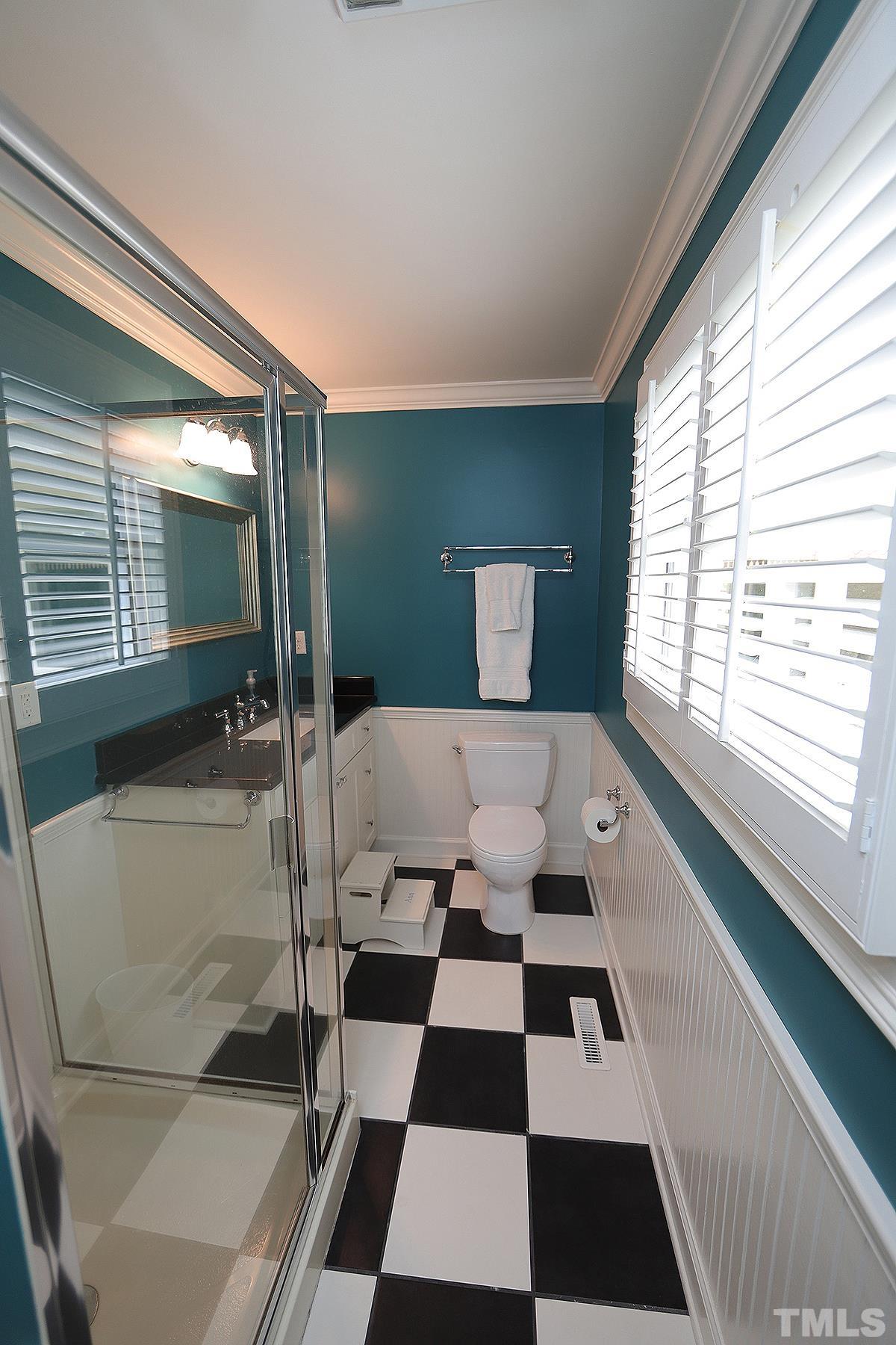 410 Marlowe Road Raleigh, NC 27609 - Photo 18 of 23 a room with a black white checkered floor with a gaming machine and dining table