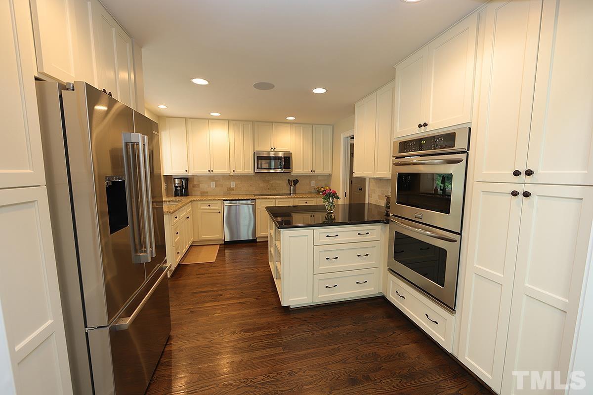 410 Marlowe Road Raleigh, NC 27609 - Photo 9 of 23 a kitchen with stainless steel appliances a refrigerator sink and stove