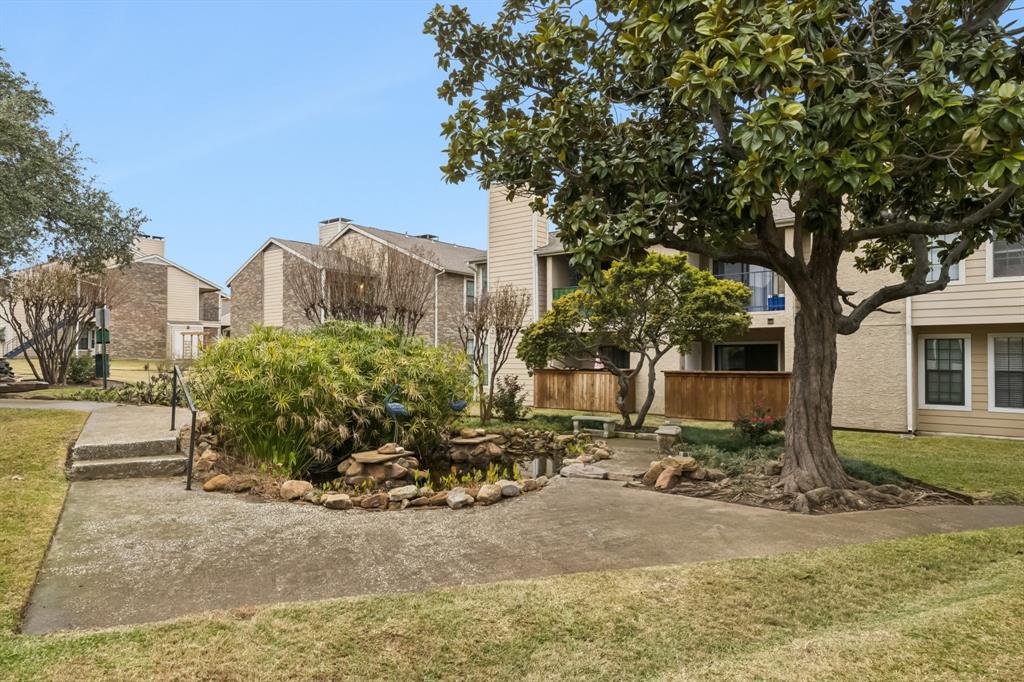 4748 Old Bent Tree Lane, Unit 1808 Dallas, TX 75287 - Photo 25 of 28 a view of a street with a building in the background