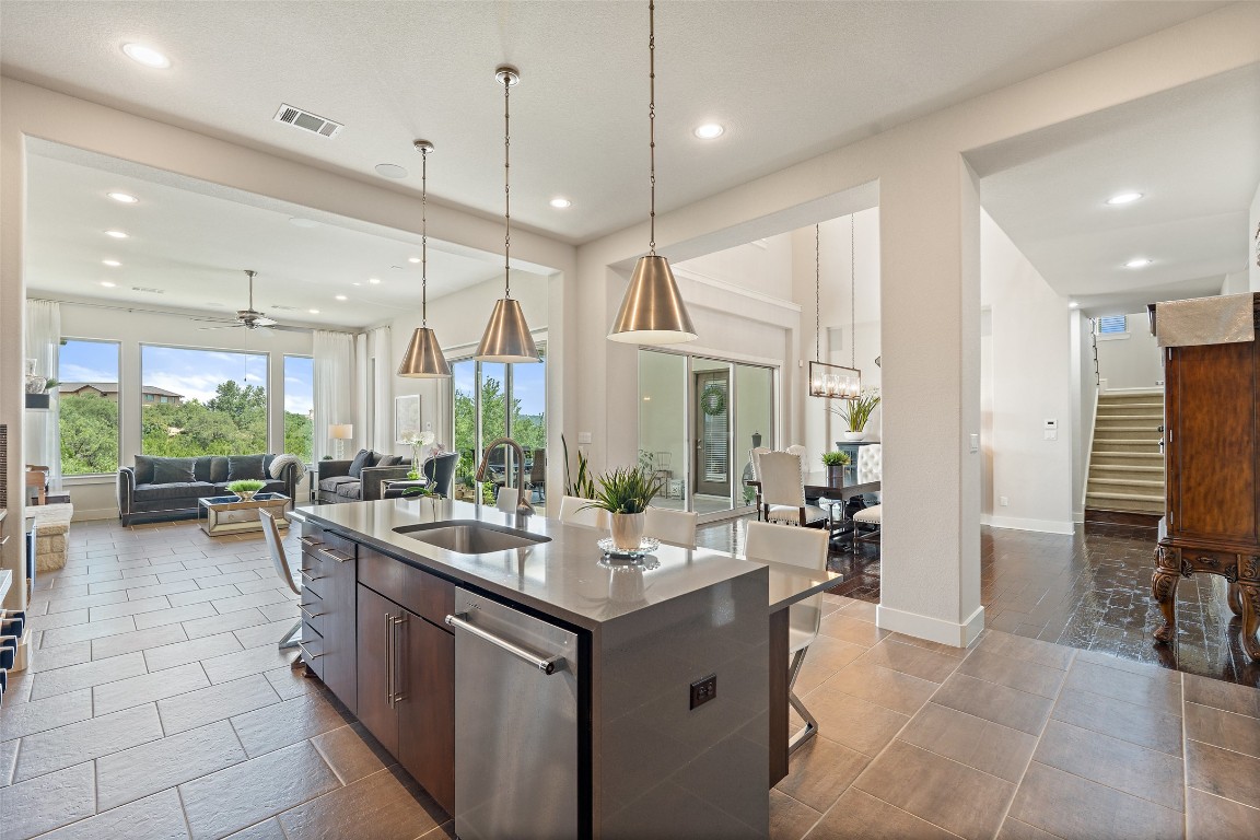 13009 Zen Gardens Way Austin, TX 78732 - Photo 11 of 40 a kitchen with sink cabinets and living room