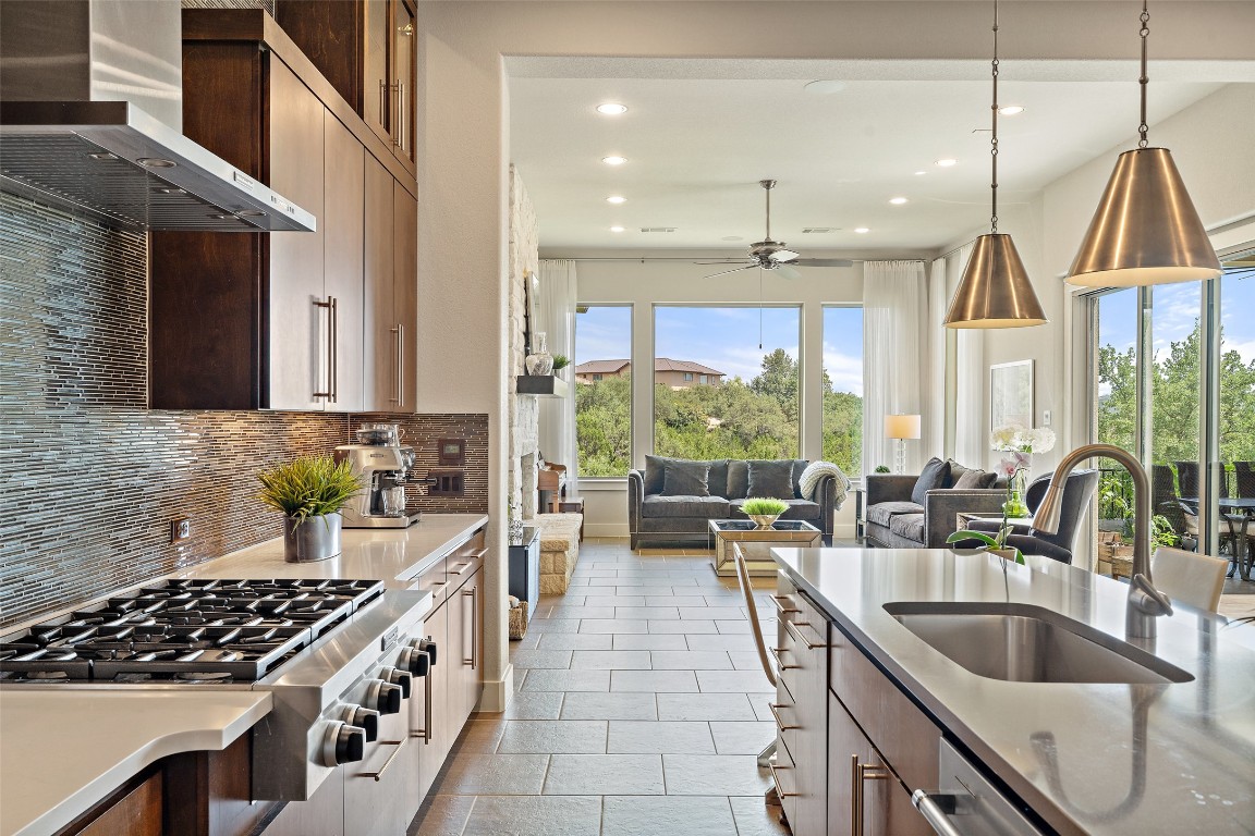 13009 Zen Gardens Way Austin, TX 78732 - Photo 12 of 40 a kitchen with counter top space a sink and appliances