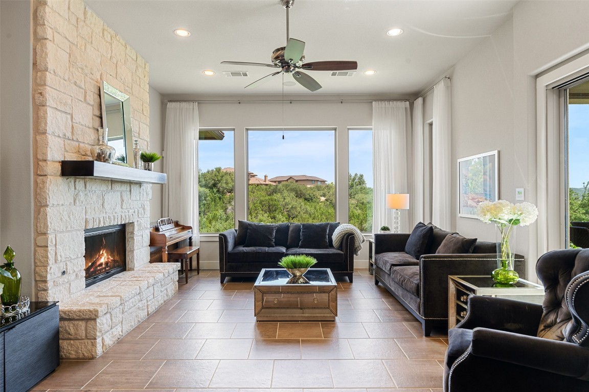 13009 Zen Gardens Way Austin, TX 78732 - Photo 13 of 40 a living room with furniture and a fireplace
