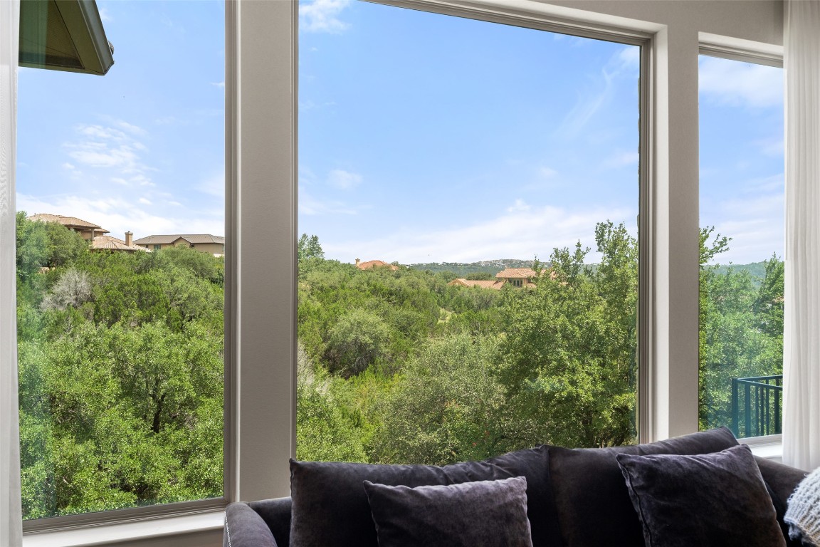 13009 Zen Gardens Way Austin, TX 78732 - Photo 14 of 40 a view of a balcony with couches and wooden floor