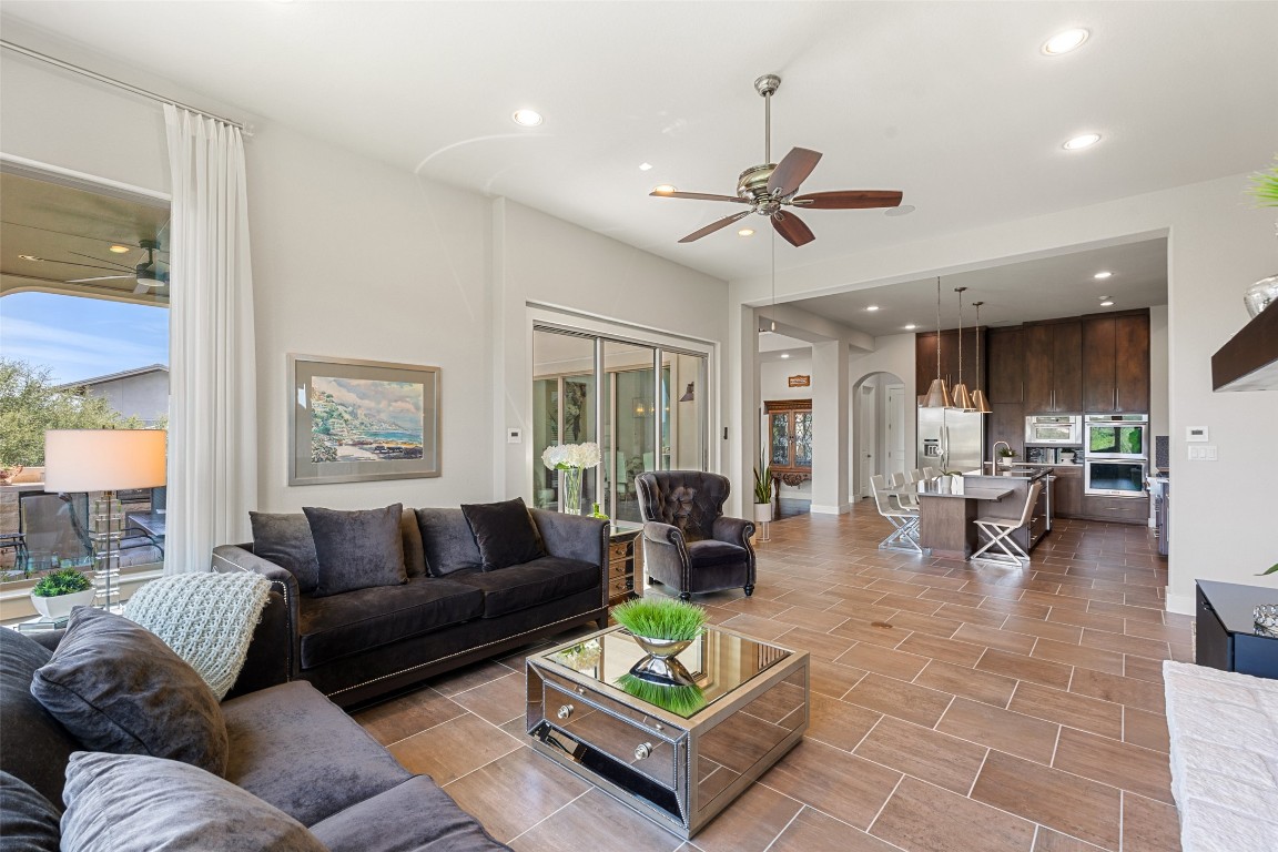 13009 Zen Gardens Way Austin, TX 78732 - Photo 15 of 40 a living room with furniture ceiling fan and a large window