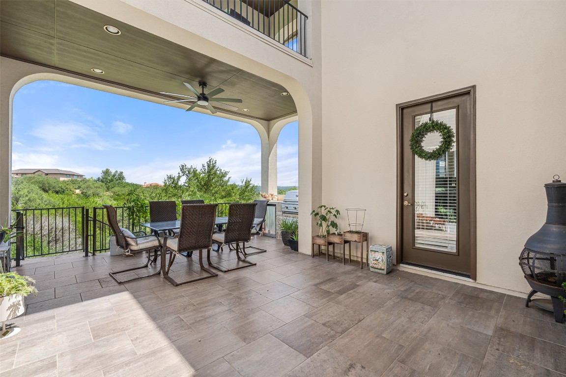 13009 Zen Gardens Way Austin, TX 78732 - Photo 16 of 40 a view of a patio with a table and chairs
