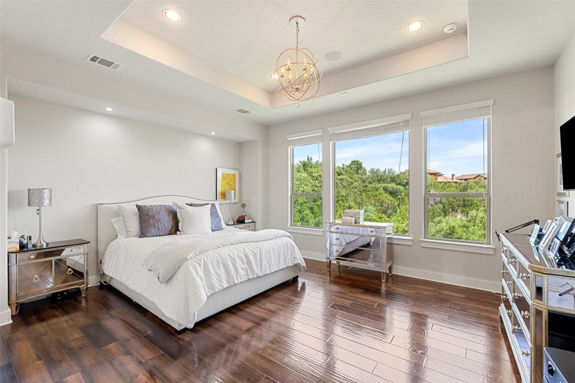 13009 Zen Gardens Way Austin, TX 78732 - Photo 19 of 40 a bedroom with a large bed and large windows