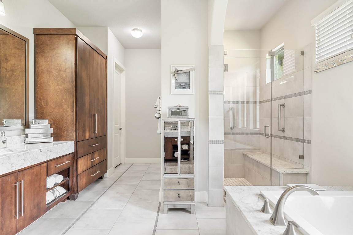 13009 Zen Gardens Way Austin, TX 78732 - Photo 21 of 40 a bathroom with a double vanity sink and a mirror