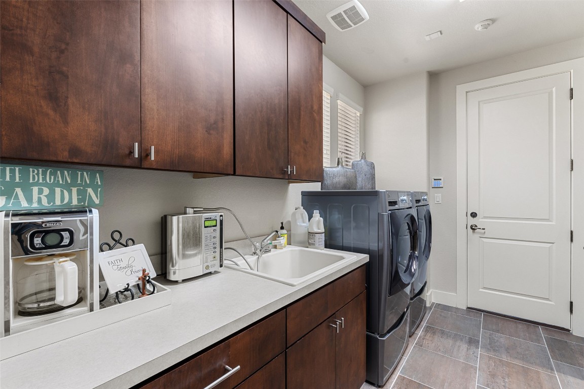 13009 Zen Gardens Way Austin, TX 78732 - Photo 24 of 40 a kitchen with a sink and cabinets