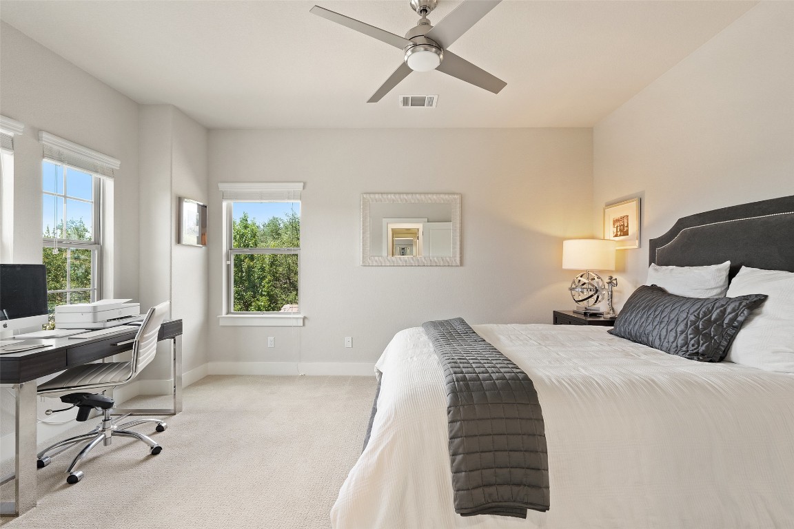 13009 Zen Gardens Way Austin, TX 78732 - Photo 31 of 40 a bedroom with a bed and a desk