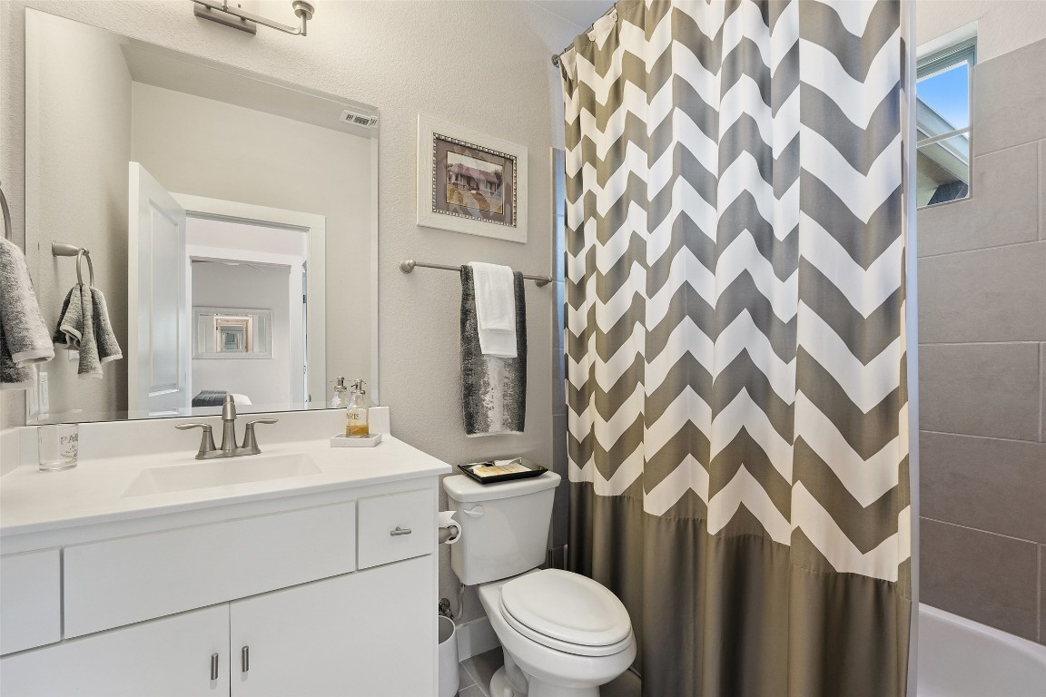 13009 Zen Gardens Way Austin, TX 78732 - Photo 32 of 40 a bathroom with a sink toilet and shower