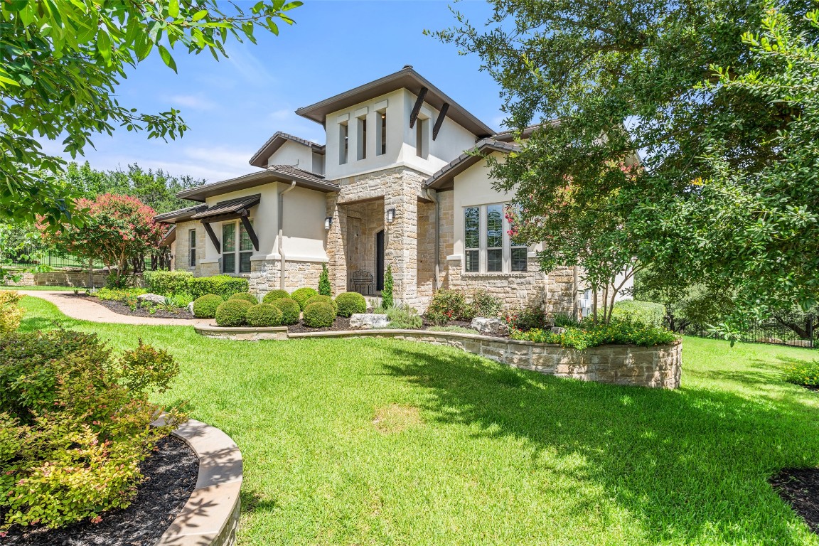 13009 Zen Gardens Way Austin, TX 78732 - Photo 39 of 40 front view of a house with a yard