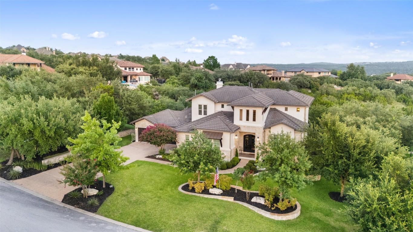 13009 Zen Gardens Way Austin, TX 78732 - Photo 40 of 40 an aerial view of a house with garden space and trees all around